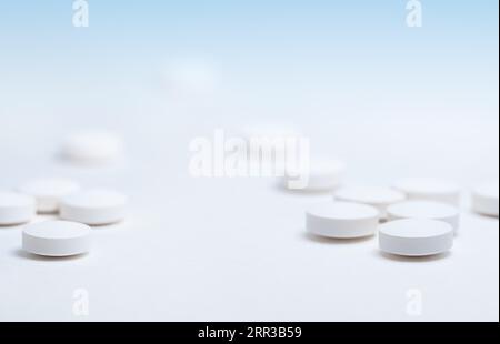 Simple plain white pills heap, medication, tablets stacked on white background Stock Photo