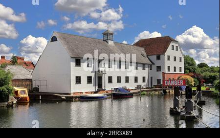 Mill House and weir  at Hambleden Lock on the river Thames in Berkshire England, with moored boats and danger sign Stock Photo