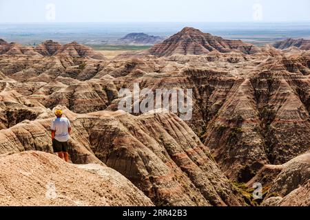 Male tourist visits Badlands National Park; White River Valley Overlook; South Dakota; USA Stock Photo