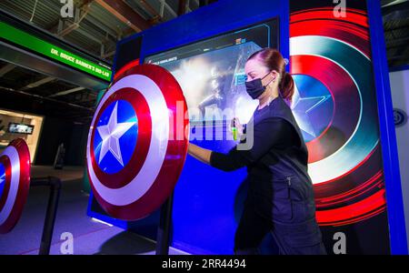 201119 -- TORONTO, Nov. 19, 2020 -- A staff member sanitizes a displayed Captain America s shield at the exhibition Marvel Avengers S.T.A.T.I.O.N. during the media preview at Yorkdale Shopping Center in Toronto, Canada, on Nov. 19, 2020. Featuring the Marvel Cinematic Universe of superheroes, the exhibition will open to the public from Nov. 20, 2020 to Jan. 31, 2021. Photo by /Xinhua CANADA-TORONTO-MARVEL AVENGERS-EXHIBITION ZouxZheng PUBLICATIONxNOTxINxCHN Stock Photo