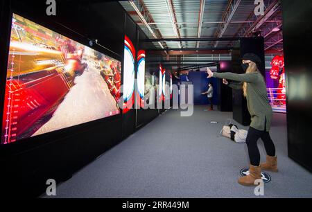 201119 -- TORONTO, Nov. 19, 2020 -- A woman wearing a face mask plays an interactive game at the exhibition Marvel Avengers S.T.A.T.I.O.N. during the media preview at Yorkdale Shopping Center in Toronto, Canada, on Nov. 19, 2020. Featuring the Marvel Cinematic Universe of superheroes, the exhibition will open to the public from Nov. 20, 2020 to Jan. 31, 2021. Photo by /Xinhua CANADA-TORONTO-MARVEL AVENGERS-EXHIBITION ZouxZheng PUBLICATIONxNOTxINxCHN Stock Photo