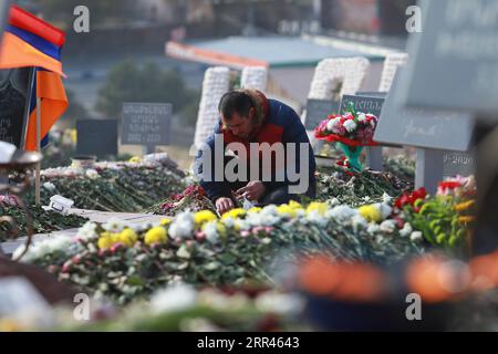 201121 -- YEREVAN, Nov. 21, 2020 -- A man buries the fallen soldiers killed in the Nagorno-Karabakh conflict in Yerevan, Armenia, Nov. 20, 2020. Azerbaijani President Ilham Aliyev, Armenian Prime Minister Nikol Pashinyan and Russian President Vladimir Putin issued a joint statement on Nov. 10, agreeing on a complete cease-fire in Nagorno-Karabakh. A key element of the joint statement was the deployment of a Russian peacekeeping contingent along the line of contact in Nagorno-Karabakh and the Lachin corridor. Azerbaijan and Armenia will also exchange war prisoners, other detained persons and bo Stock Photo