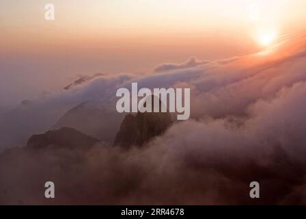 Sun rising above the clouds in the morning at Huangshan (Yellow Mountain) in Anhui province, China. Stock Photo