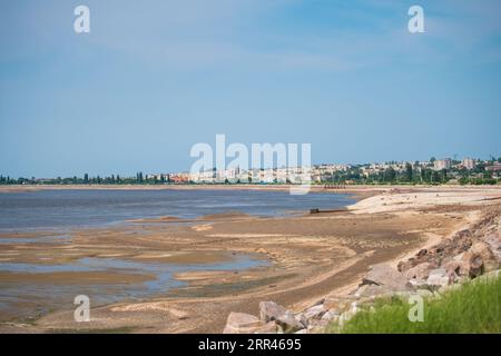 Nikopol city, Dnipropetrovsk Oblast with terrible Disaster Ecocide landscape of dried up Kakhovka Reservoir near Enerhodar as result of Kakhovka Dam d Stock Photo