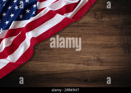 Top view overhead America United States flag, memorial remembrance and thank you of hero, studio shot with copy space on wooden table background, USA. Stock Photo