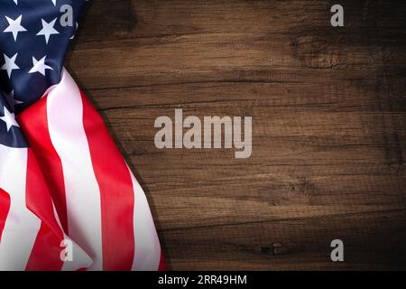 Top view overhead America United States flag, memorial remembrance and thank you of hero, studio shot with copy space on wooden table background, USA. Stock Photo