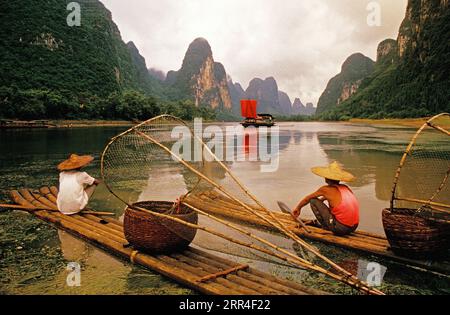 Li River, Guangxi, China: Cormorant fishermen at rest of their bamboo rafts on the river near Xingping (Guilin area). Stock Photo
