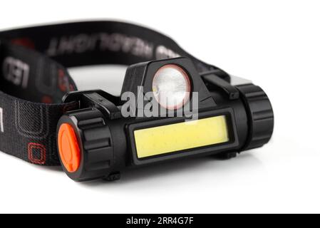 Head Torch flashlight on white background isolation. Light battery operated lamp worn on head. Stock Photo