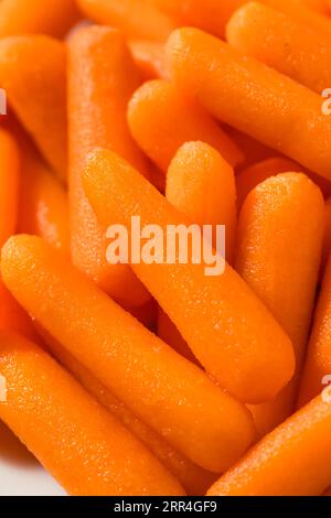 Orange Organic Raw Baby Carrots in a Bowl Stock Photo