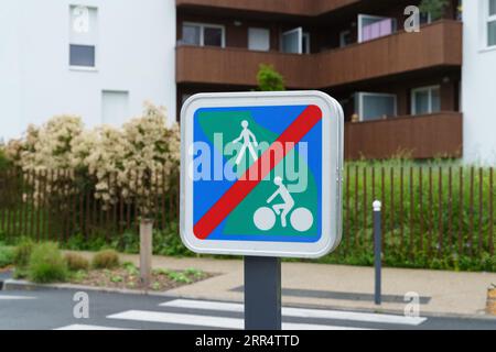 Road sign - the end of a green road in a residential area, set in front of a pedestrian crossing. Close-up. Stock Photo