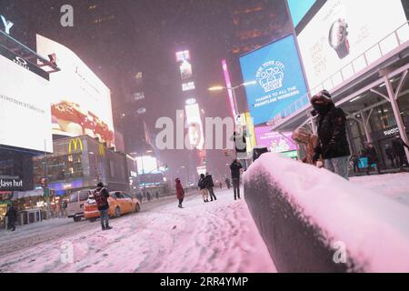 201217 -- NEW YORK, Dec. 17, 2020 -- People take photos on Times Square in New York, the United States, Dec. 16, 2020. A snow storm hit New York on Wednesday.  U.S.-NEW YORK-SNOW WangxYing PUBLICATIONxNOTxINxCHN Stock Photo
