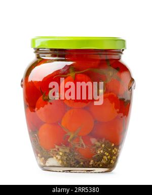 Canned cherry tomatoes in a closed glass jar isolated on a white background, close-up. Pickled tomatoes with spices Stock Photo