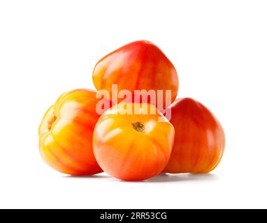 A hill of organic yellow-red striped tomatoes isolated on a white background, close-up. Stock Photo