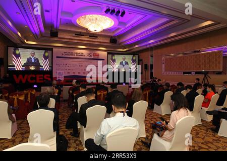 201221 -- KUALA LUMPUR, Dec. 21, 2020  -- Participants listen to a video address by Malaysian Prime Minister Muhyiddin Yassin at the World Chinese Economic Summit 2020 held in Kuala Lumpur, Malaysia, Dec. 21, 2020. China has played a significant role in upholding the international trading system and opposing protectionism and unilateralism since the outbreak of COVID-19, Malaysian Prime Minister Muhyiddin Yassin said on Monday. TO GO WITH China has played significant role in upholding int l trading system: Malaysian PM  MALAYSIA-KUALA LUMPUR-WORLD CHINESE ECONOMIC SUMMIT Xinhua PUBLICATIONxNOT Stock Photo