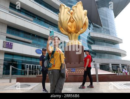 201224 -- HONG KONG, Dec. 24, 2020 -- A visitor takes photos at the Golden Bauhinia Square in south China s Hong Kong, May 1, 2020.  CHINA-HONG KONG-CITY VIEW CN WuxXiaochu PUBLICATIONxNOTxINxCHN Stock Photo