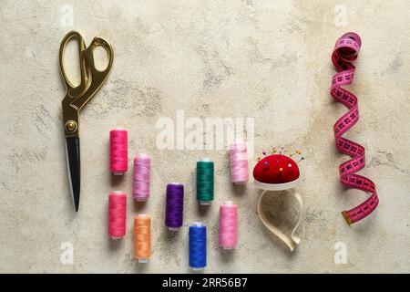 Composition with different sewing supplies on grunge background Stock Photo