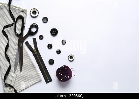Composition with different sewing supplies on light background Stock Photo