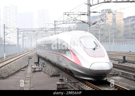 201224 -- CHONGQING, Dec. 24, 2020 -- The Fuxing high-speed train G8608 bound for Chengdu East Railway Station in southwest China s Sichuan Province, pulls out the Shapingba Railway Station in southwest China s Chongqing on Dec. 24, 2020. On Thursday morning, with G8608 and G8607 trains respectively pulling out of Chongqing Shapingba Railway Station and Chengdu East Railway Station, the Fuxing CR400AF trains plying on the railway linking Chengdu, capital of Sichuan Province, and Chongqing Municipality were officially put into operation at a speed of 350 km/h, reducing the travel time to about Stock Photo