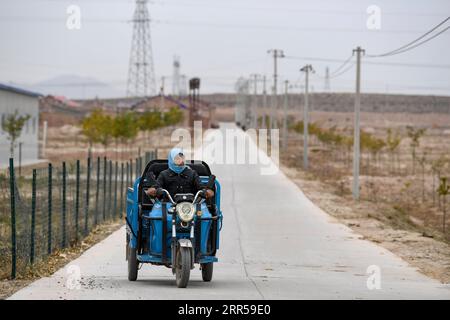 201228 -- YINCHUAN, Dec. 28, 2020 -- Li Yaomei is on the way to the broom factory in Longyuan Village of Hongsibao District in Wuzhong City, northwest China s Ningxia Hui Autonomous Region, Oct. 27, 2020. Xihaigu, a largely mountainous region in central-southern Ningxia, was once inflicted by deep poverty and labeled the most unfit place for human settlement by the United Nations in the 1970s due to land reclamation, drought, and a fragile ecological environment. On Nov. 16, 2020, Xihaigu historically bid farewell to absolute poverty, during which she power played an indispensable role. Li Yao Stock Photo