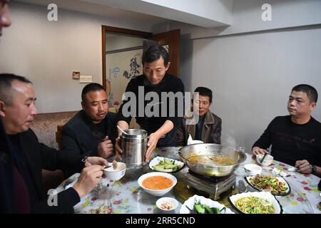210101 -- CHANGSHA, Jan. 1, 2021 -- Shi Zhongfang C serves the customers at his restaurant in Yuanjiang City, central China s Hunan Province, Dec. 21, 2020. Shi Zhongfang, a former fisherman in Lianhua ao Island which is located in the middle of Dongting Lake, now runs a restaurant featuring the traditional fish cuisine of fishermen in Yuanjiang City. He was the seventh generation fisherman in his family and started fishing at the age of 14. His life has changed in the wake of a fishing ban. According to the central government s plan, a complete 10-year fishing ban is imposed in key waters of Stock Photo