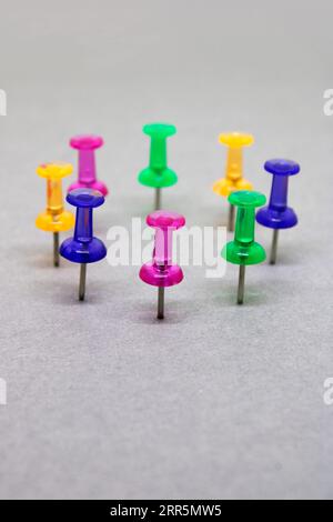 Group of thumbtacks of diferent colors formed in circle Stock Photo