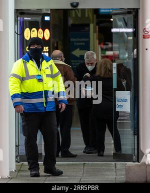 210113 -- LONDON, Jan. 13, 2021 -- A security personnel is seen outside the Vaccination Centre at ExCel exhibition centre in London, Britain, Jan. 12, 2021. British Prime Minister Boris Johnson on Monday warned against false complacency as the country is seeking to speed up the coronavirus vaccine rollout. According to the prime minister, 2.4 million coronavirus jabs have been administered across Britain. Seven new mass vaccination sites in England opened Monday, as the country races against time to bring the pandemic under control.  BRITAIN-LONDON-COVID-19-VACCINE ROLLOUT HanxYan PUBLICATIONx Stock Photo