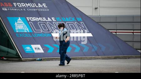 210113 -- LONDON, Jan. 13, 2021 -- A staff wearing a face mask walks into the Vaccination Centre at ExCel exhibition centre in London, Britain, on Jan. 12, 2021. British Prime Minister Boris Johnson on Monday warned against false complacency as the country is seeking to speed up the coronavirus vaccine rollout. According to the prime minister, 2.4 million coronavirus jabs have been administered across Britain. Seven new mass vaccination sites in England opened Monday, as the country races against time to bring the pandemic under control.  BRITAIN-LONDON-COVID-19-VACCINE ROLLOUT HanxYan PUBLICA Stock Photo