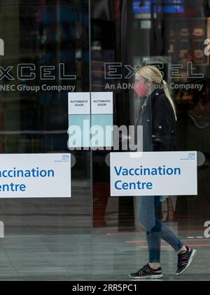 210113 -- LONDON, Jan. 13, 2021 -- A woman wearing a face mask is seen in the Vaccination Centre at ExCel exhibition centre in London, Britain, Jan. 12, 2021. British Prime Minister Boris Johnson on Monday warned against false complacency as the country is seeking to speed up the coronavirus vaccine rollout. According to the prime minister, 2.4 million coronavirus jabs have been administered across Britain. Seven new mass vaccination sites in England opened Monday, as the country races against time to bring the pandemic under control.  BRITAIN-LONDON-COVID-19-VACCINE ROLLOUT HanxYan PUBLICATIO Stock Photo