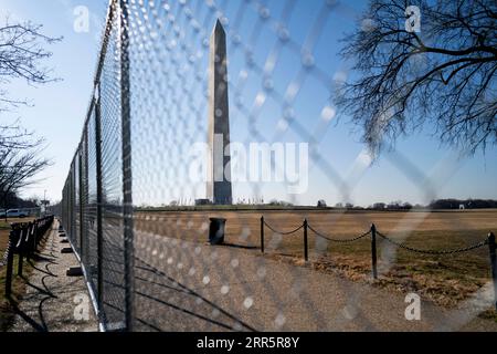 210114 -- WASHINGTON, Jan. 14, 2021 -- Photo taken on Jan. 13, 2021 shows the Washington Monument seen through a barrier fence in Washington, D.C., the United States. U.S. President Donald Trump on Monday approved the emergency declaration for Washington, D.C., the nation s capital, through Jan. 24, covering the date of President-elect Joe Biden s inauguration on Jan. 20.  U.S.-WASHINGTON-EMERGENCY DECLARATION LiuxJie PUBLICATIONxNOTxINxCHN Stock Photo