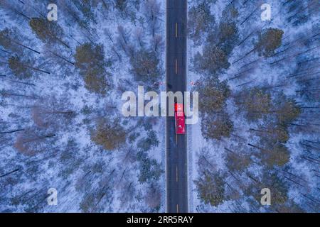 210114 -- MOHE, Jan. 14, 2021 -- Aerial photo shows a fire engine patrolling on a road in Beiji Village of Mohe City, northeast China s Heilongjiang Province, Jan. 13, 2021. Firefighters stick to their post and keep training despite the freezing weather in Mohe, the northernmost city in China, where the temperature is often below minus 40 degrees Celsius in winter.  CHINA-HEILONGJIANG-MOHE-WINTER-FIRE FIGHTERSCN XiexJianfei PUBLICATIONxNOTxINxCHN Stock Photo