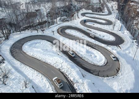 210114 -- SRINAGAR, Jan. 14, 2021 -- Aerial photo taken on Jan. 14, 2021 shows a mountain road after snowfall in Anantnag district, south of Srinagar city, the summer capital of Indian-controlled Kashmir.  KASHMIR-WINTER SCENERY JavedxDar PUBLICATIONxNOTxINxCHN Stock Photo