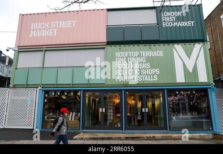 210120 -- LONDON, Jan. 20, 2021 -- A woman wearing a face mask walks past the closed Buck Street Market in London, Britain, on Jan. 19, 2021. The number of people who have died within 28 days of a positive coronavirus test has surpassed the grim milestone of 90,000 in Britain after another 1,610 were confirmed, according to official figures released Tuesday. The latest daily death toll, the highest since the pandemic began in the country, brought the total number of coronavirus-related deaths in Britain to 91,470, the data showed.  BRITAIN-LONDON-COVID-19-DEATH TOLL HanxYan PUBLICATIONxNOTxINx Stock Photo