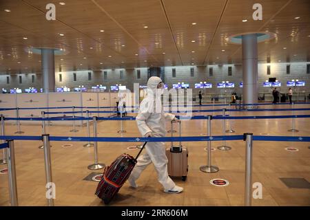 210120 -- TEL AVIV, Jan. 20, 2021 -- A passenger wearing a protective suit and mask walks at Ben Gurion International Airport near Tel Aviv, Israel, Jan. 19, 2021. Israel s cabinet decided on Tuesday to extend by 10 days a weeks-long nationwide lockdown to curb the spread of the COVID-19 pandemic. The ministers voted in favor of extending the tight lockdown until Jan. 31, according to a cabinet statement. The cabinet also decided that travelers entering the country will be required to present a negative coronavirus test taken within 72 hours before their flight. Gideon Markowicz/JINI via Xinhu Stock Photo