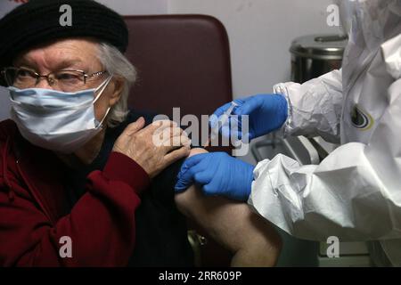 210120 -- ANKARA, Jan. 20, 2021 -- An elderly woman receives an injection of COVID-19 vaccine at a nursing home in Ankara, Turkey, on Jan. 19, 2021. Turkey s vaccination campaign on Tuesday extended to the people staying and working in care and nursing homes and the citizens over 90. The state-run TRT news broadcaster released footage of the elderly and their caregivers getting their first doses of the COVID-19 vaccine developed by China s Sinovac at the nursing homes on Tuesday. The elderly over 90 also received their vaccines at home. Photo by /Xinhua TURKEY-ANKARA-COVID-19-VACCINATION Musta Stock Photo