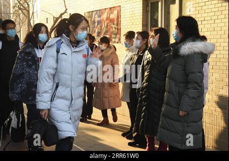210122 -- BEIJING, Jan. 22, 2021 -- Students on the third grade of the junior section of the High School Affiliated to China Agricultural University wave goodbye to their teachers before leaving campus in Beijing, capital of China, Jan. 21, 2021. All primary schools in Beijing have been on winter vacation since Jan. 16. Classes on the first and second grades of junior sections of high schools here are slated to start their winter vacations as of Jan. 23. Classes on all other grades of high schools are expected to complete their off-line academic activities by Jan. 23, and all students on these Stock Photo