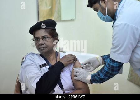 210121 -- AGARTALA, Jan. 21, 2021  -- A health worker of the Border Security Force receives a dose of the COVID-19 vaccine Covishield at Agartala, the capital city of India s northeastern state of Tripura, Jan. 21, 2021. Str/ INDIA-COVID-19-VACCINATION Xinhua PUBLICATIONxNOTxINxCHN Stock Photo