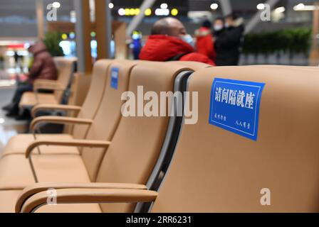 210122 -- BEIJING, Jan. 22, 2021 -- Signs reminding people to sit by distance are seen at the waiting hall of Beijing Chaoyang Railway Station in Beijing, capital of China, Jan. 22, 2021. China on Friday launched a new high-speed railway service that connects Beijing with Harbin, capital of the northeastern province of Heilongjiang. A newly unveiled 192-km-long section, running from Beijing to Chengde, in the neighboring Hebei Province, started operation Friday morning. Combined with two previously opened sections, the Beijing-Harbin high-speed railway extends 1,198 km. The new railway service Stock Photo