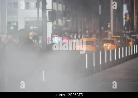 210124 -- NEW YORK, Jan. 24, 2021 -- People wearing face masks walks on the street in New York, the United States, Jan. 23, 2021. The total number of confirmed COVID-19 cases in the United States topped 24.99 million, according to the data released by Johns Hopkins University on Saturday. Photo by /Xinhua U.S.-COVID-19-CONFIRMED CASES MichaelxNagle PUBLICATIONxNOTxINxCHN Stock Photo