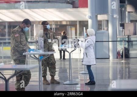 210124 -- NEW YORK, Jan. 24, 2021 -- National Guard members assist people at a COVID-19 vaccination center at the Jacob K. Javits Convention Center in New York, the United States, Jan. 23, 2021. The total number of confirmed COVID-19 cases in the United States topped 24.99 million, according to the data released by Johns Hopkins University on Saturday. Photo by /Xinhua U.S.-COVID-19-CONFIRMED CASES MichaelxNagle PUBLICATIONxNOTxINxCHN Stock Photo