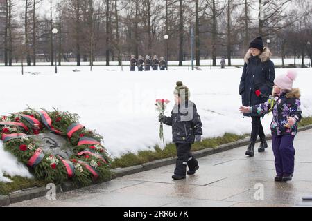 210128 -- ST. PETERSBURG, Jan. 28, 2021 -- Children lay flowers at the Piskaryovskoye Memorial Cemetery in St. Petersburg, Russia, Jan. 27, 2021. Activities were held here to mark the 77th anniversary of ending the Nazi siege of Leningrad during World War II. Leningrad was besieged by the Nazi troops on Sept. 8, 1941 and the siege was lifted on Jan. 27, 1944. Photo by /Xinhua RUSSIA-ST. PETERSBURG-LENINGRAD BLOCKADE-ANNIVERSARY IrinaxMotina PUBLICATIONxNOTxINxCHN Stock Photo