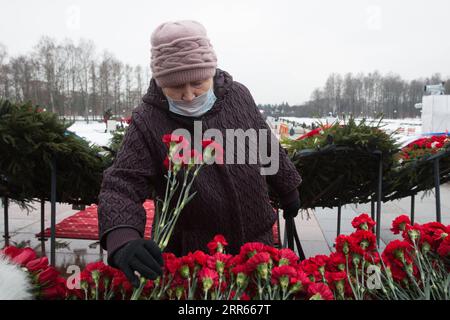 210128 -- ST. PETERSBURG, Jan. 28, 2021 -- A citizen lays flowers at the Piskaryovskoye Memorial Cemetery in St. Petersburg, Russia, Jan. 27, 2021. Activities were held here to mark the 77th anniversary of ending the Nazi siege of Leningrad during World War II. Leningrad was besieged by the Nazi troops on Sept. 8, 1941 and the siege was lifted on Jan. 27, 1944. Photo by /Xinhua RUSSIA-ST. PETERSBURG-LENINGRAD BLOCKADE-ANNIVERSARY IrinaxMotina PUBLICATIONxNOTxINxCHN Stock Photo