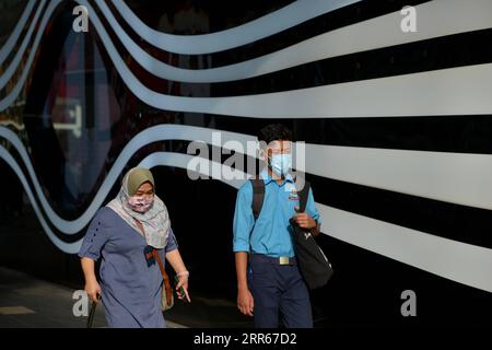 210129 -- KUALA LUMPUR, Jan. 29, 2021 -- People wearing face masks walk on a street in Kuala Lumpur, Malaysia, Jan. 29, 2021. Malaysia recorded 5,725 confirmed cases of COVID-19 in its highest daily spike since the outbreak of the coronavirus in the Asian country, bringing its total tally to 203,933, the Health Ministry said on Friday. Photo by /Xinhua MALAYSIA-KUALA LUMPUR-COVID-19-CASES ChongxVoonxChung PUBLICATIONxNOTxINxCHN Stock Photo