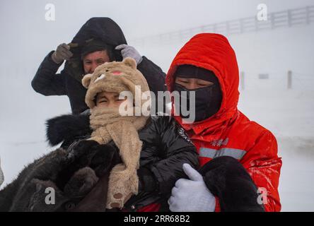 210131 -- URUMQI, Jan. 31, 2021 -- A staff member of the Maytas wind prevention and rescuing base transfers stranded passengers in Maytas, Emin County of northwest China s Xinjiang Uygur Autonomous Region, Jan. 23, 2021. Maytas, located in Emin County, is an important thoroughfare with tough weather conditions of snowstorms and heavy wind for about half a year. Since 2002, the Maytas wind prevention and rescuing base has been responsible for road clearing and rescuing of the S201 in the region. For people who are on duty here, work can last day and night. They patrol on every windy and snowy d Stock Photo