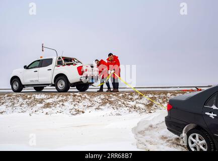 210131 -- URUMQI, Jan. 31, 2021 -- Staff of the Maytas wind prevention and rescuing base check the rope to drag a car in Maytas, Emin County of northwest China s Xinjiang Uygur Autonomous Region, Jan. 24, 2021. Maytas, located in Emin County, is an important thoroughfare with tough weather conditions of snowstorms and heavy wind for about half a year. Since 2002, the Maytas wind prevention and rescuing base has been responsible for road clearing and rescuing of the S201 in the region. For people who are on duty here, work can last day and night. They patrol on every windy and snowy day, rescue Stock Photo