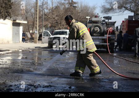 210206 -- KABUL, Feb. 6, 2021 -- A firefighter washes the site of an attack in Kabul, Afghanistan, Feb. 6, 2021. A police officer was killed and six civilians were wounded in two separate bomb explosions in Kabul, capital of Afghanistan on Saturday, the latest in a string of bomb attacks in recent months, the capital police confirmed. Photo by /Xinhua SPOT NEWSAFGHANISTAN-KABUL-EXPLOSION SayedxMominzadah PUBLICATIONxNOTxINxCHN Stock Photo