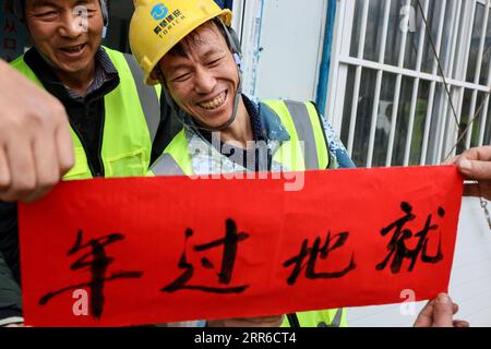210206 -- GUIYANG, Feb. 6, 2021 -- Workers put up Spring Festival couplets at the construction site of the Huawei Cloud data center in Guian New Area, southwest China s Guizhou Province, Feb. 6, 2021. Workers who have decied to stay put celebrated the upcoming Spring Festival together at the construction site.  CHINA-GUIZHOU-DATA CENTER-FESTIVAL CN OuxDongqu PUBLICATIONxNOTxINxCHN Stock Photo