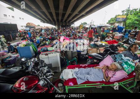 210210 -- BEIJING, Feb. 10, 2021 -- People take a rest under a bridge as temporary shelter after flood hit the place due to high intensity of rainfall in Subang, West Java, Indonesia, Feb. 9, 2021. Photo by /Xinhua XINHUA PHOTOS OF THE DAY Septianjar PUBLICATIONxNOTxINxCHN Stock Photo