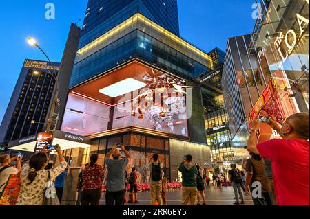 210211 -- BEIJING, Feb. 11, 2021 -- People take photos and video clips of the 3D golden bull video shown on the LED screen outside a shopping mall in Kuala Lumpur, Malaysia, Feb. 10, 2021. Photo by /Xinhua XINHUA PHOTOS OF THE DAY ChongxVoonxChung PUBLICATIONxNOTxINxCHN Stock Photo