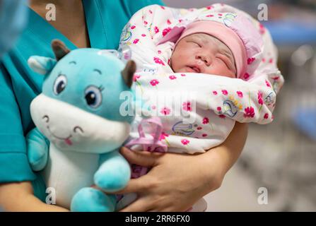 210213 -- URUMQI, Feb. 13, 2021 -- A baby born in the Year of the Ox is seen at the maternity ward of Urumqi Maternal and Child Health Hospital in Urumqi, northwest China s Xinjiang Uygur Autonomous Region, Feb. 12, 2021. With advanced equipment and sufficient personnel, Urumqi Maternal and Child Health Hospital has one of the most popular maternity wards in the region. Medical workers here stick to their posts during the Spring Festival vacation. To better control and prevent the COVID-19 pandemic, negative nucleic acid testing reports are required for all expectant mothers before they move i Stock Photo