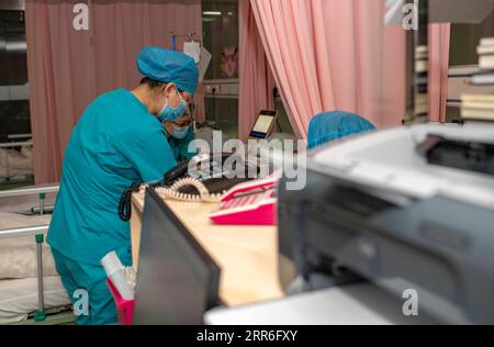 210213 -- URUMQI, Feb. 13, 2021 -- Midwives take care of an expectant mother at the maternity ward of Urumqi Maternal and Child Health Hospital in Urumqi, northwest China s Xinjiang Uygur Autonomous Region, Feb. 12, 2021. With advanced equipment and sufficient personnel, Urumqi Maternal and Child Health Hospital has one of the most popular maternity wards in the region. Medical workers here stick to their posts during the Spring Festival vacation. To better control and prevent the COVID-19 pandemic, negative nucleic acid testing reports are required for all expectant mothers before they move i Stock Photo